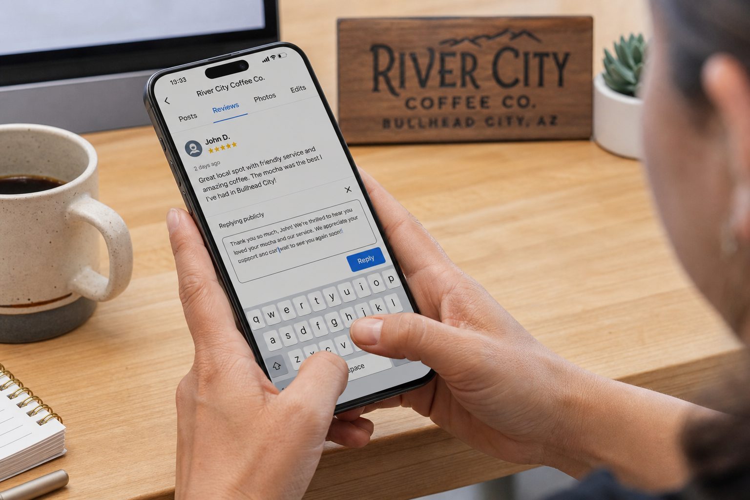 Close-up of hands typing a reply to a customer review on a phone