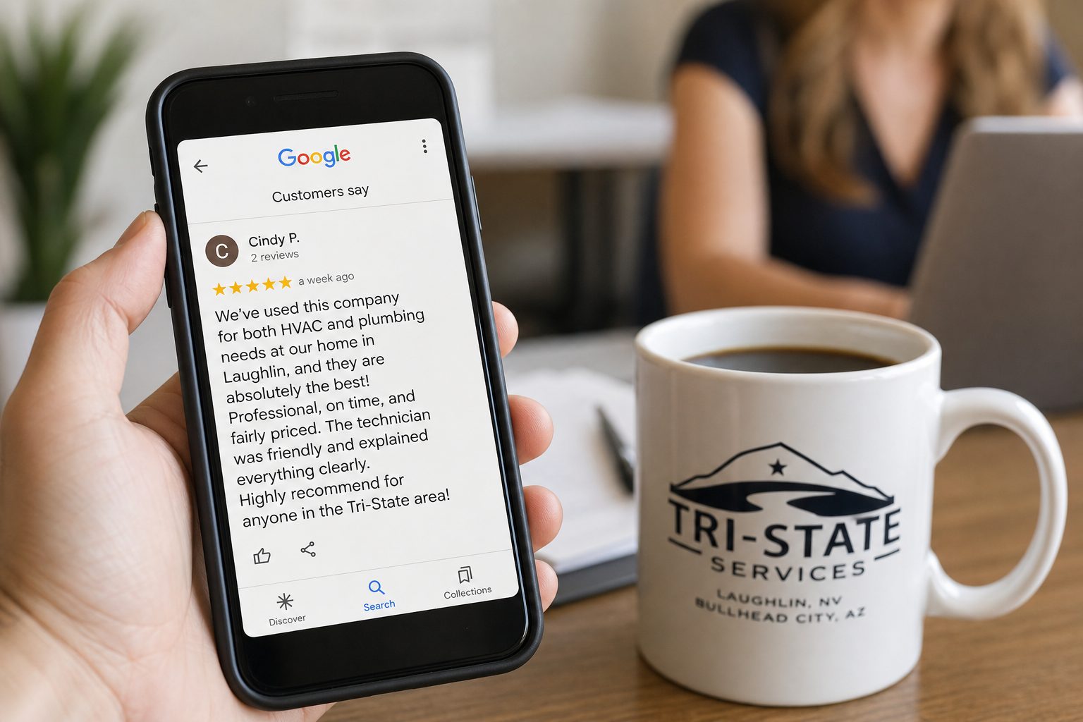 Phone showing a five-star Google review beside a coffee cup on a desk